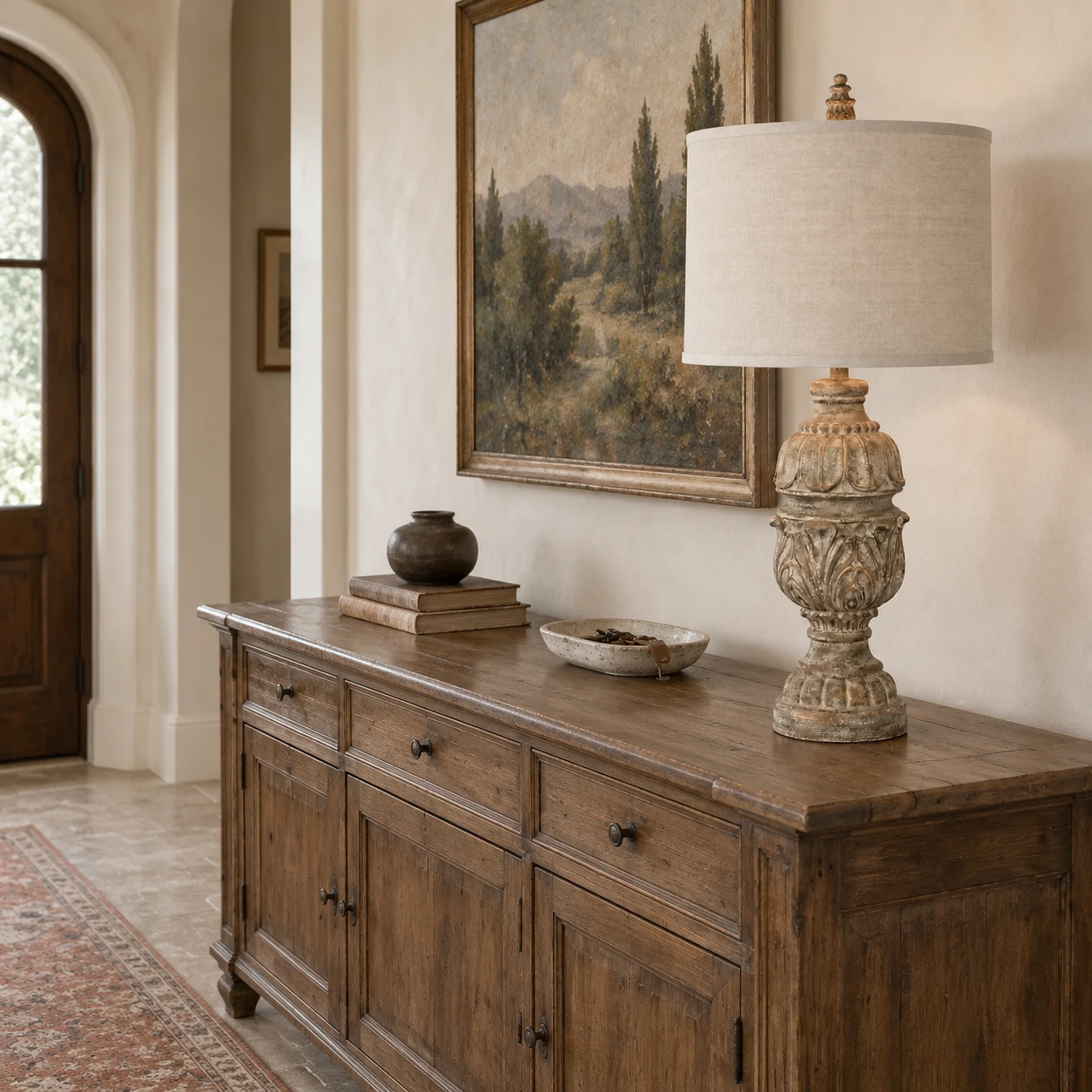 Carved wood table lamp on a wide entry console
