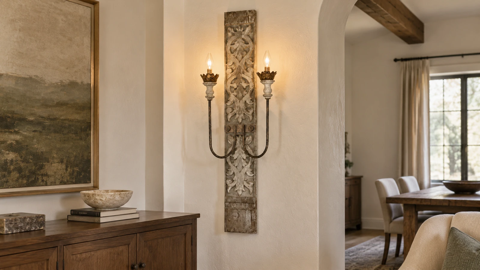 Marielle carved wall sconce above a walnut sideboard