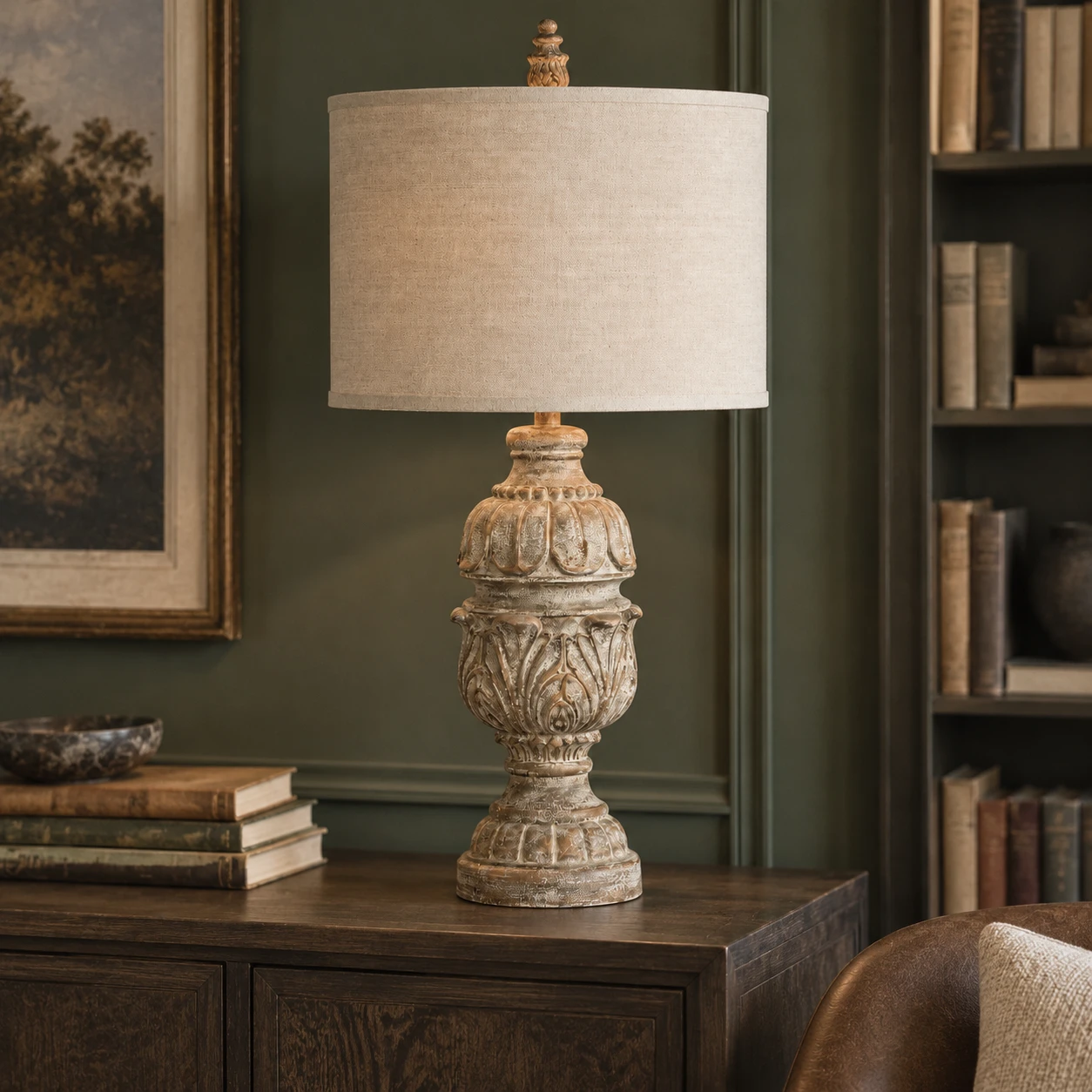 Carved wood table lamp on a home library credenza