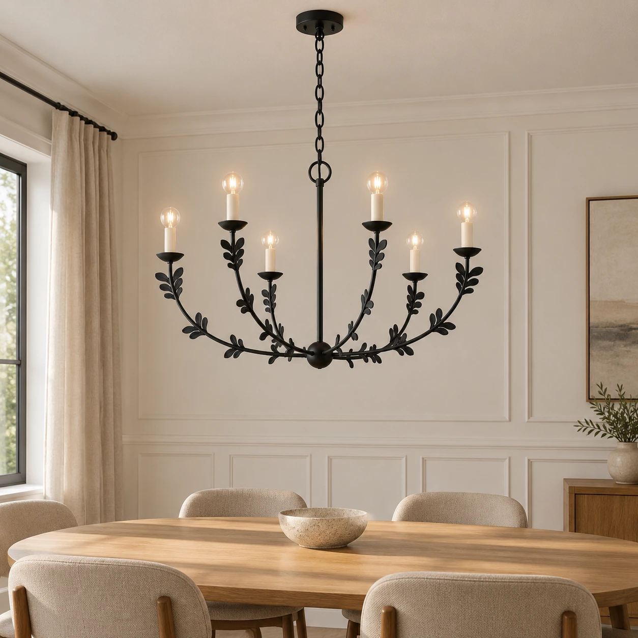 Black chandelier over an oval oak dining table
