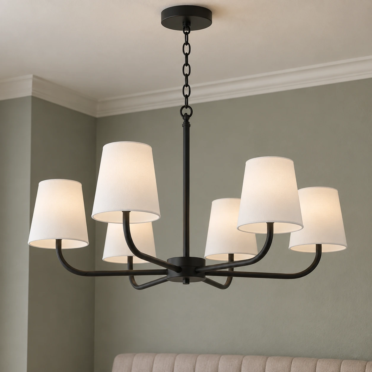 Black chandelier in a muted green living area