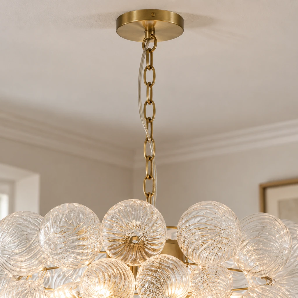 Close detail of the round brass canopy and oval-link chain