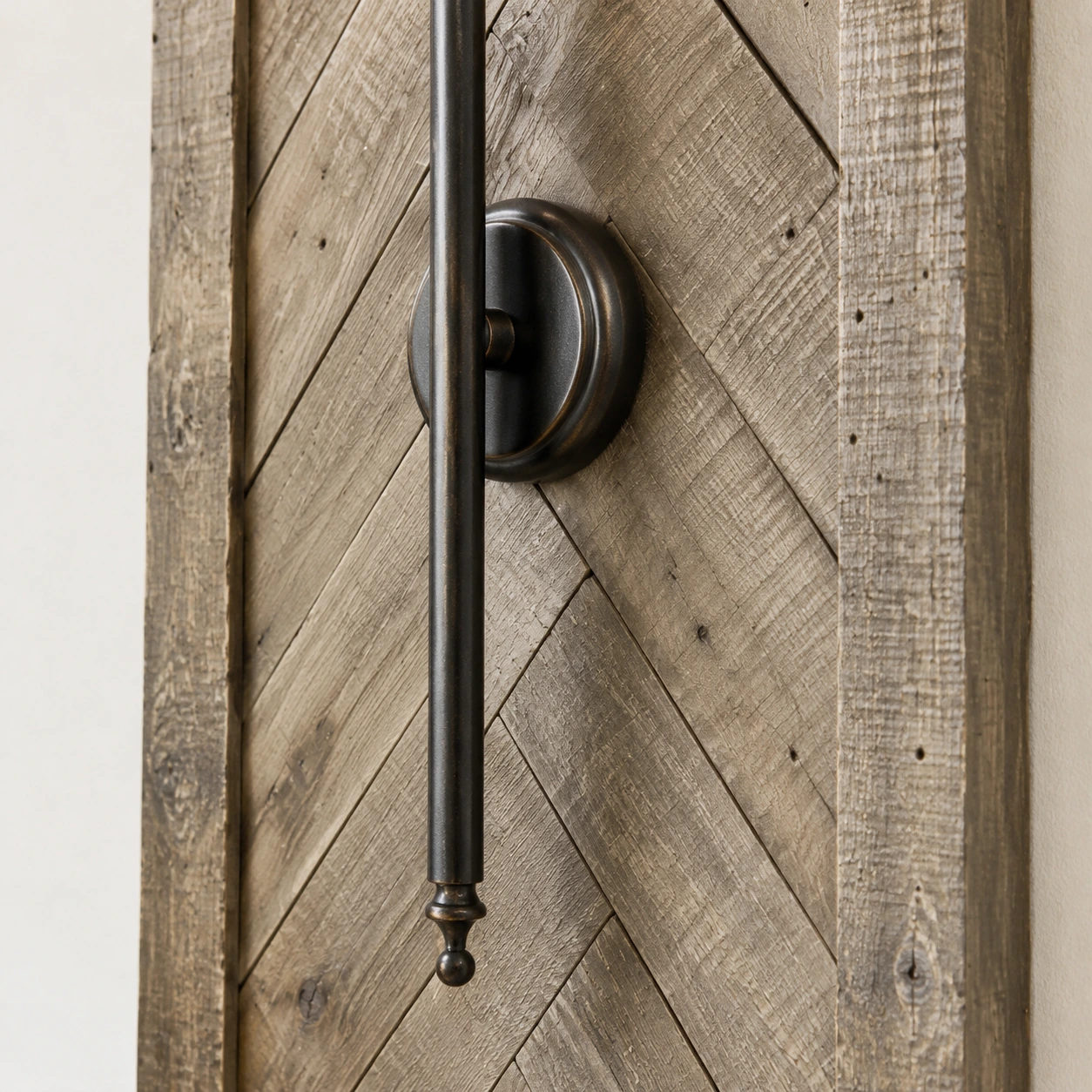 Vertical iron rod on a weathered wood panel
