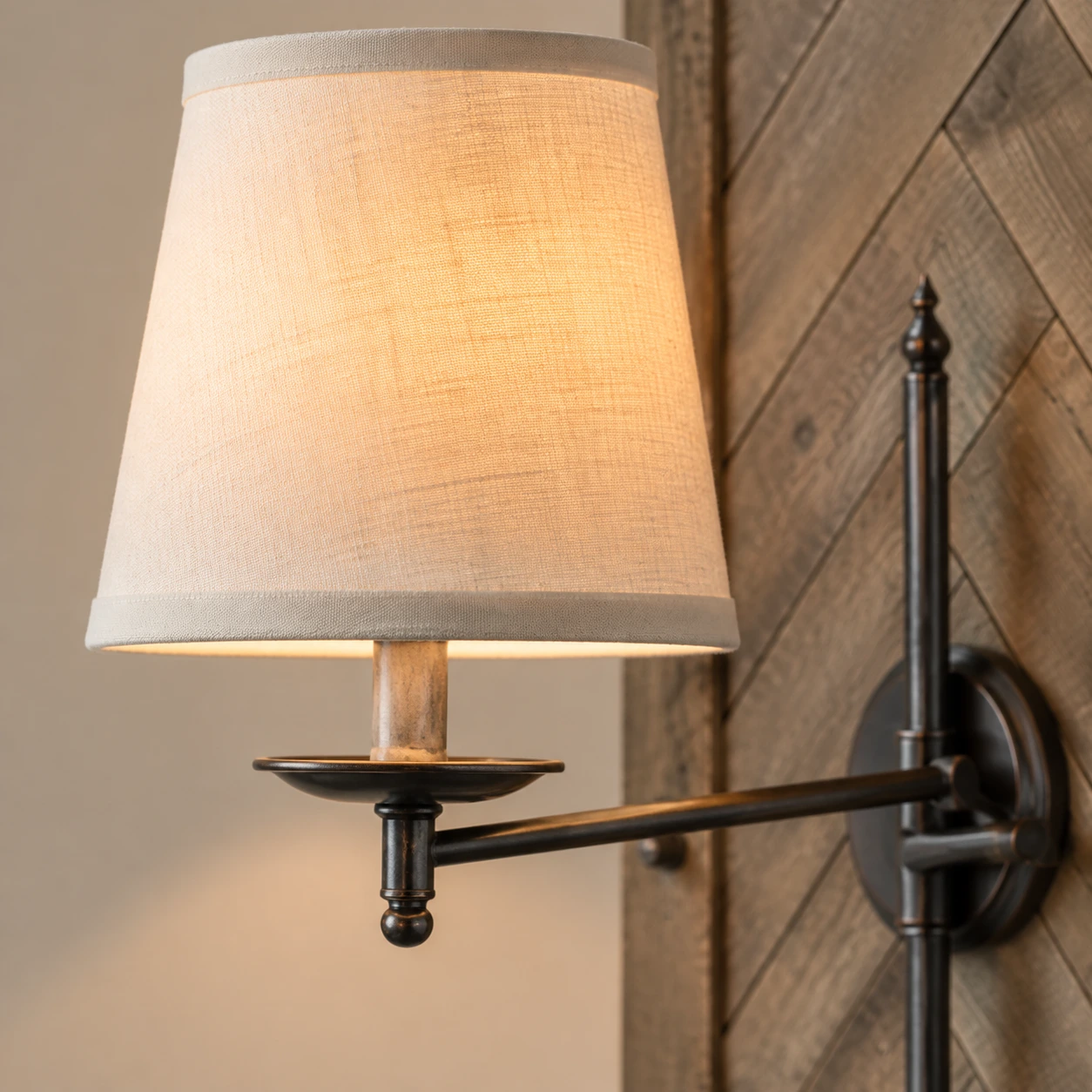 Single ivory fabric shade and dark iron arm detail