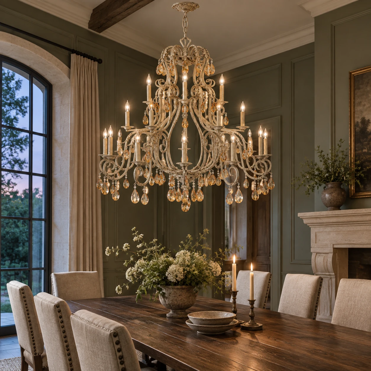 Large crystal chandelier above a dining table at dusk
