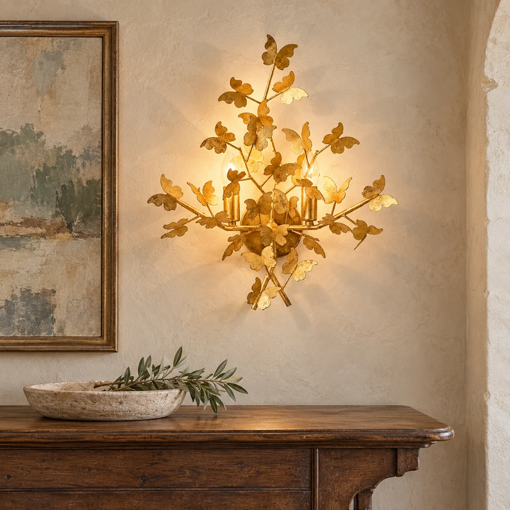 Nora gold-leaf wall light above a walnut console