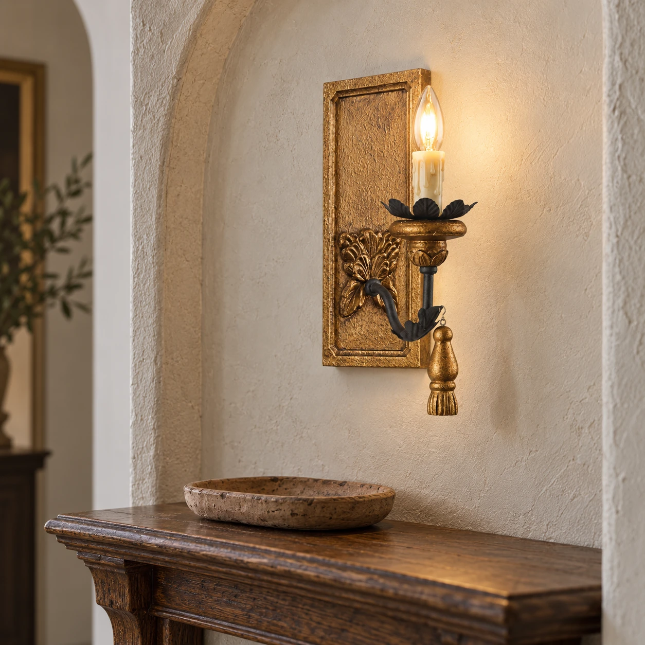 Wood wall sconce alongside an entry console