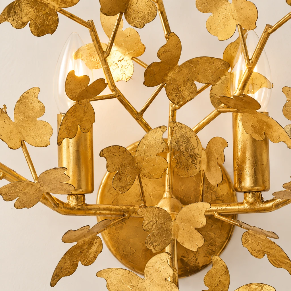 Close detail of Nora layered gold-leaf butterfly leaves and branch junction