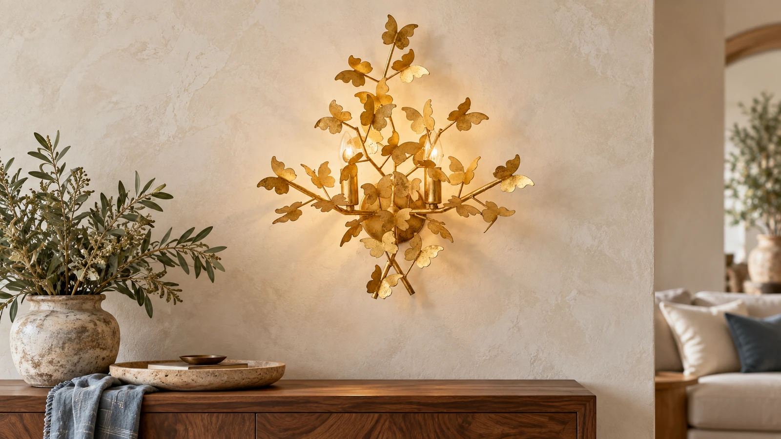 Nora gold-leaf butterfly wall light above a walnut console