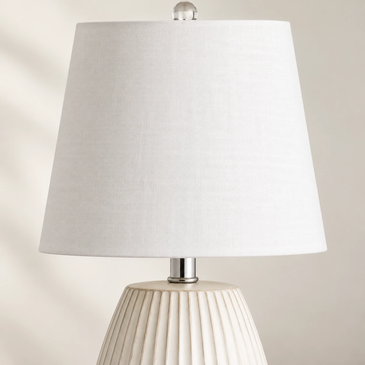 Close detail of the white fabric shade and metal neck