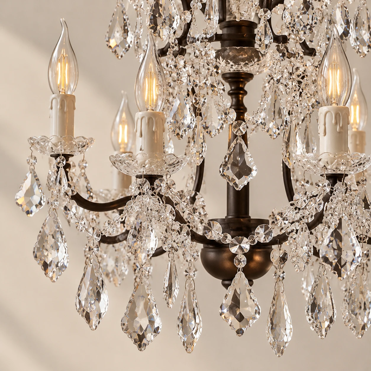 Close detail of clear crystal drops and painted iron candle arms