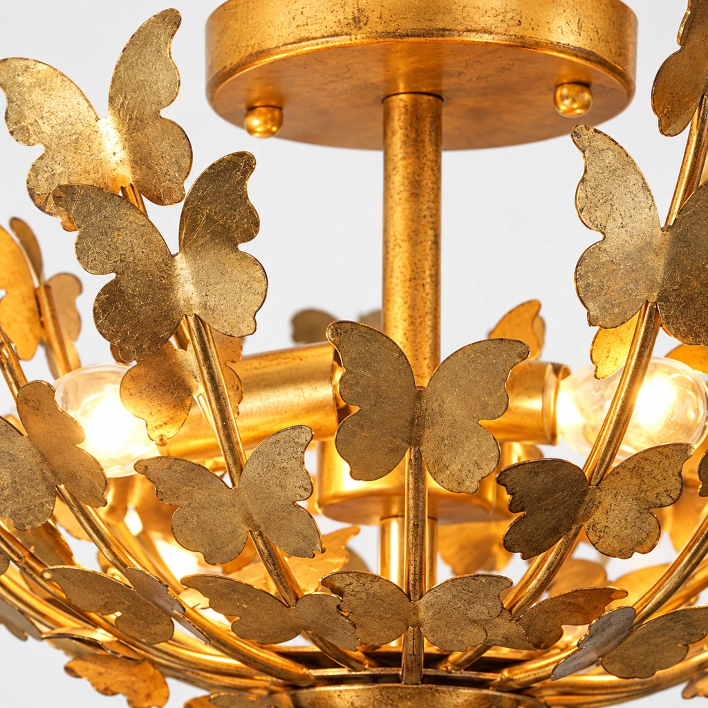 Close detail of Elena gold-leaf iron butterfly wing and branch junction