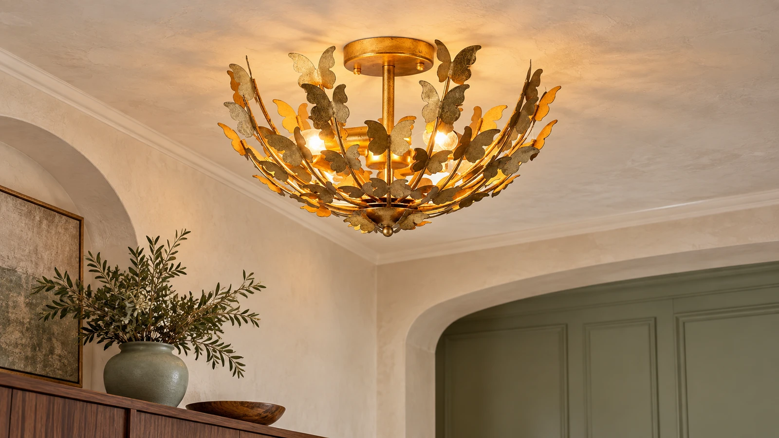 Elena butterfly ceiling light beside a French vintage console