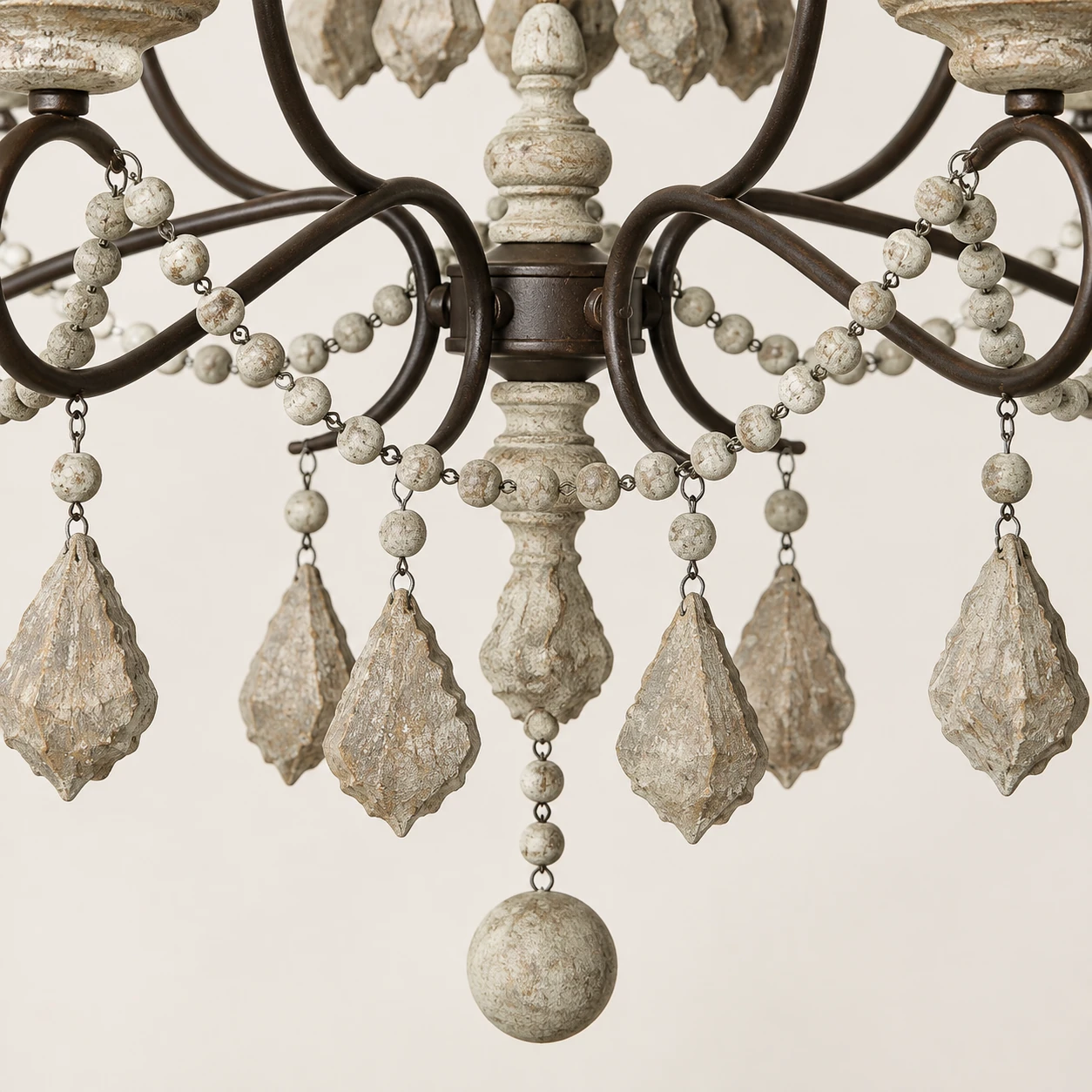 Close detail of Mara hanging wood-toned drops and lower finial