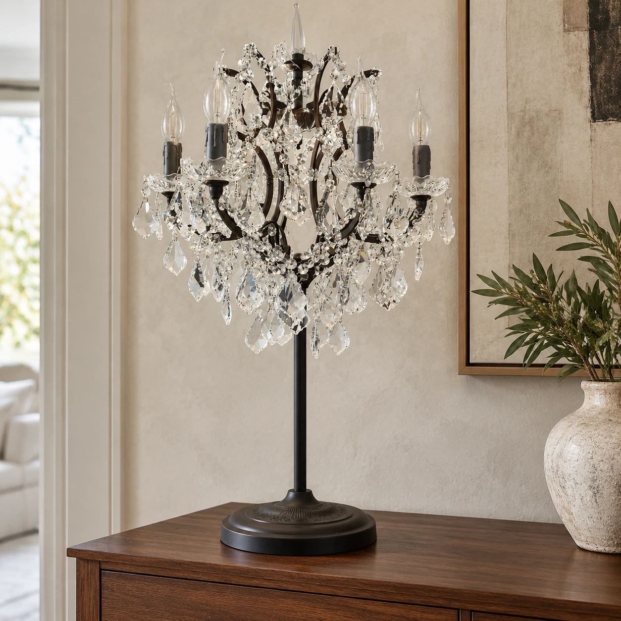 Celeste crystal candle table lamp on a walnut living-room console