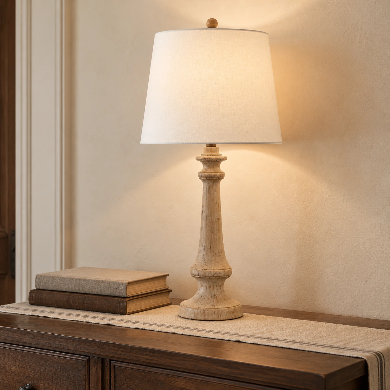 Turned wood table lamp on a walnut console