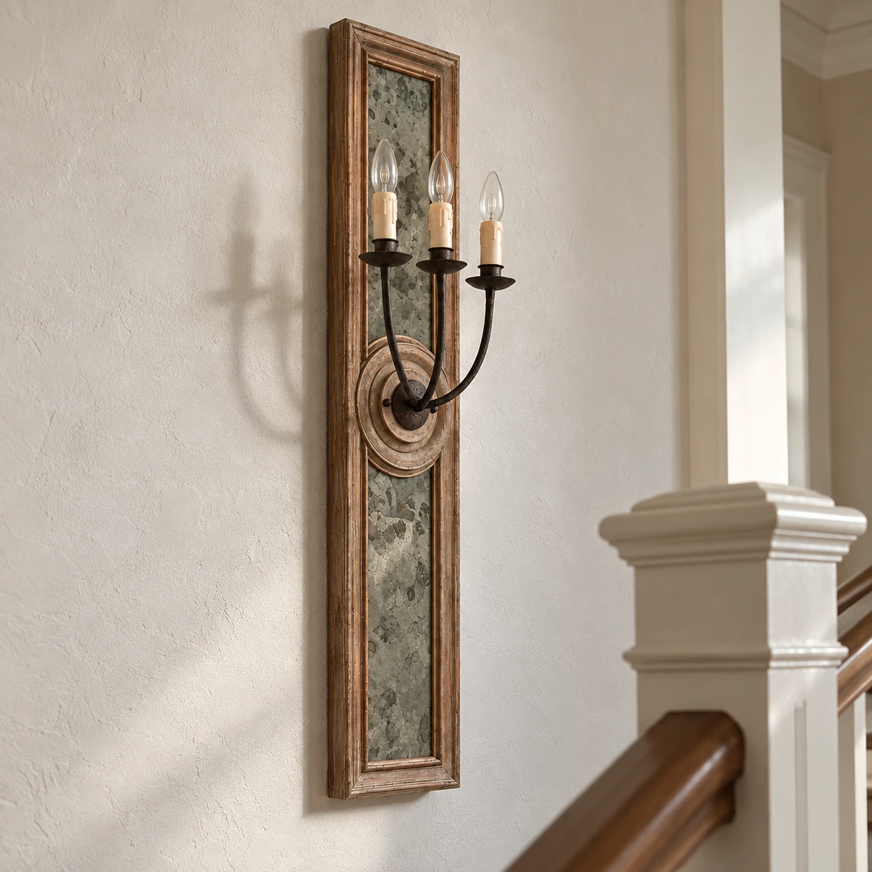 Maren carved wood wall sconce in a traditional entry