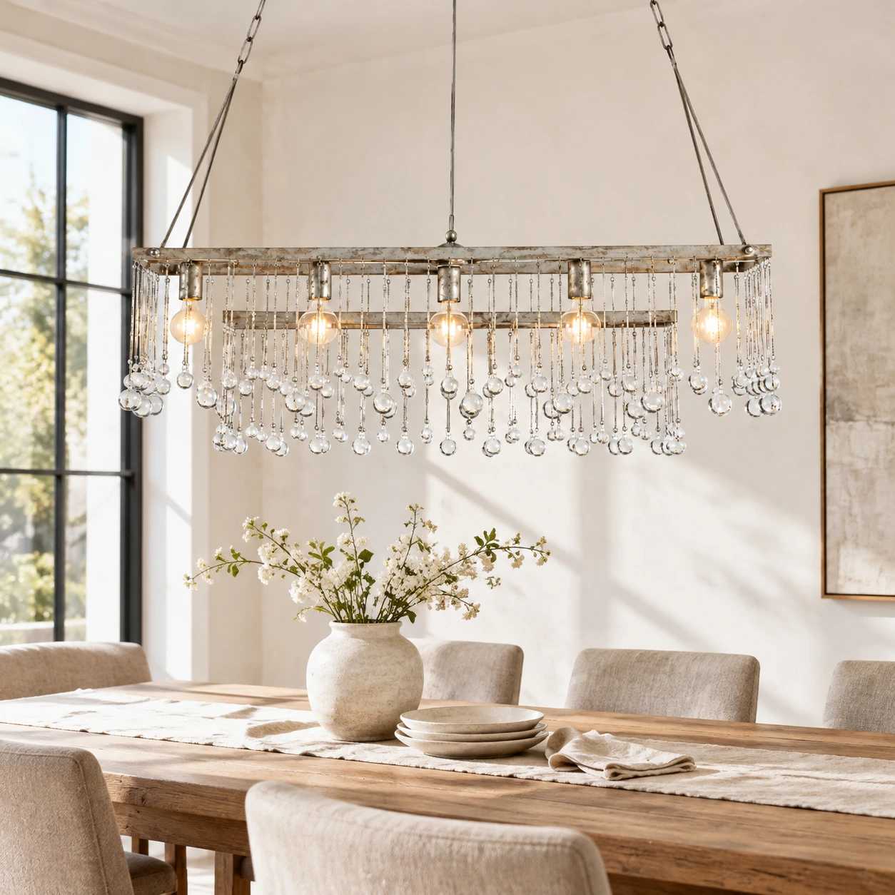 Silver-finish rectangular crystal chandelier above a café table