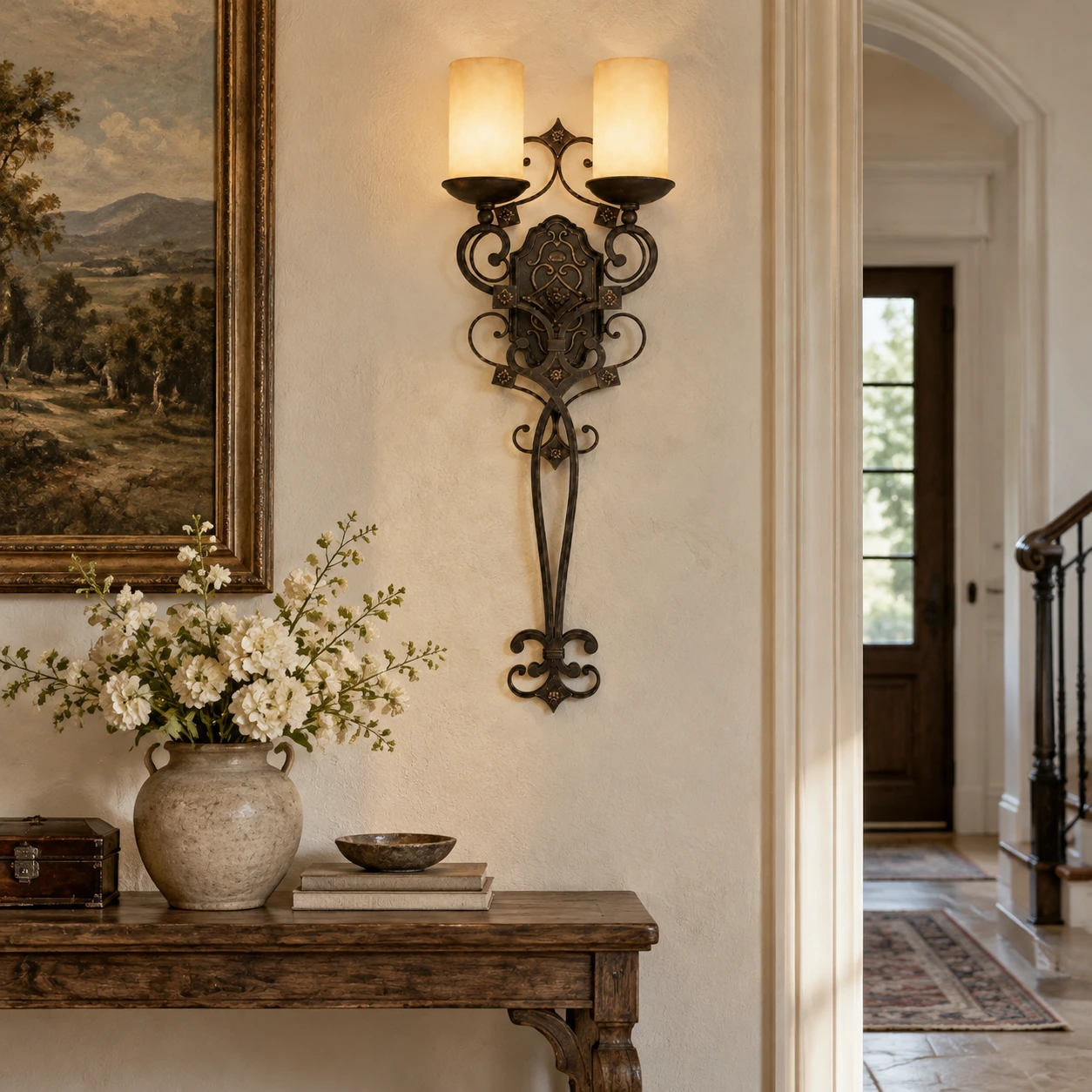Amelie French Country Double-Candle Iron Wall Sconce mounted above an entryway console