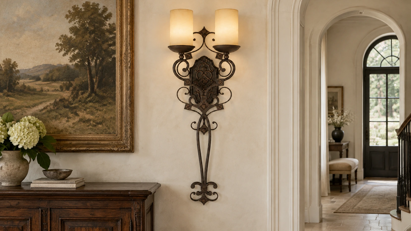 Amelie French Country Double-Candle Iron Wall Sconce centered in a French country entry hall