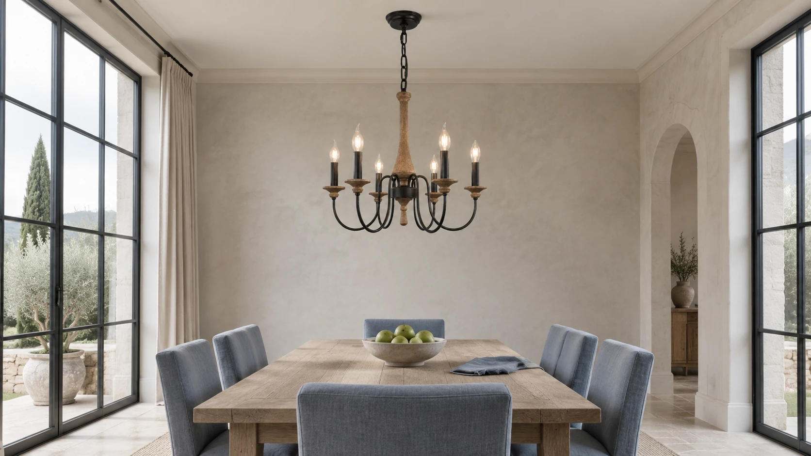 Carved wood branch chandelier over a bright residential dining room