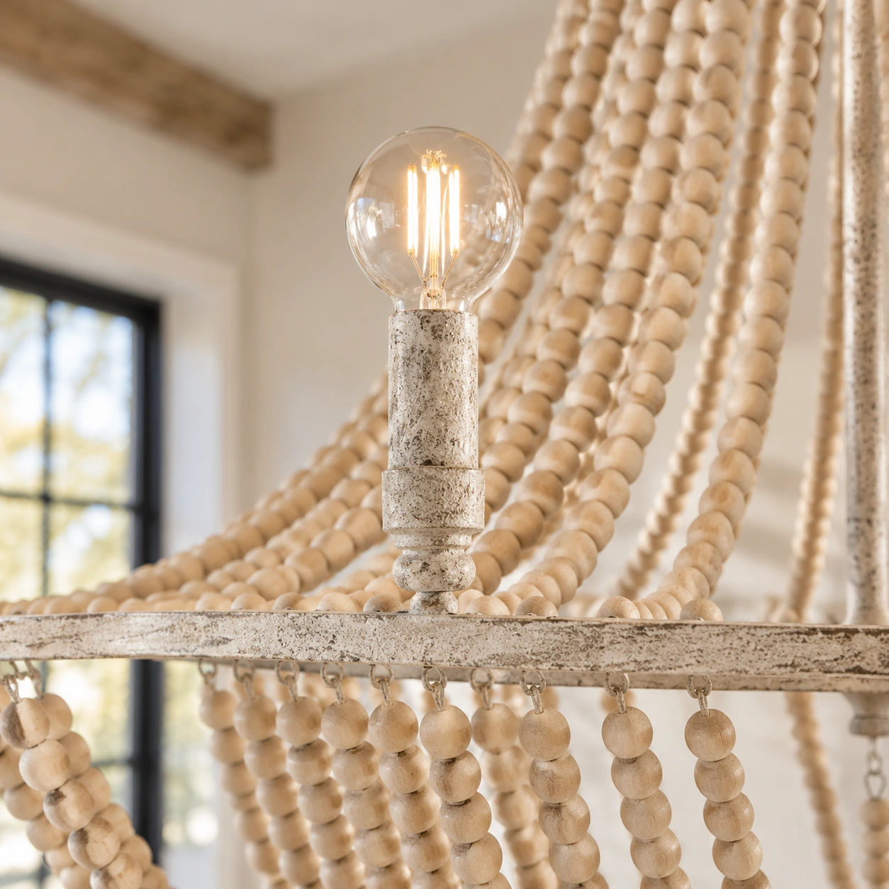 Close detail of the wood bead strands, iron frame, and lamp socket