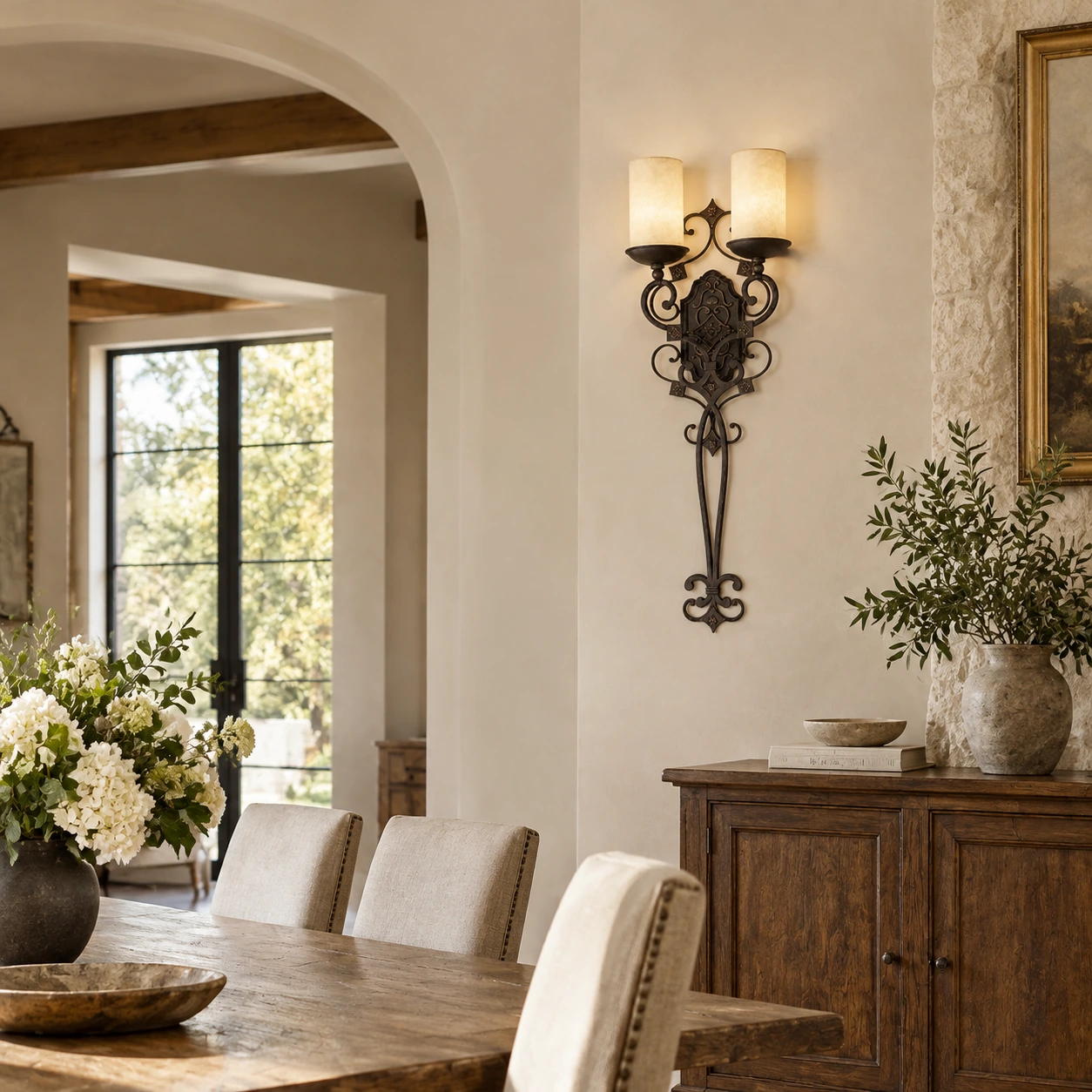 Amelie French Country Double-Candle Iron Wall Sconce mounted on a dining room side wall
