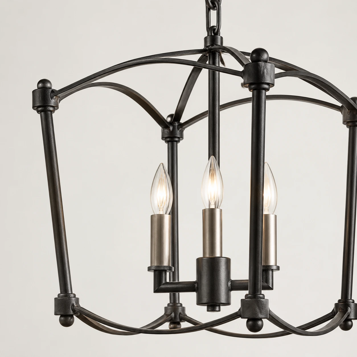 Close view of the Mabel chandelier's matte black birdcage iron frame