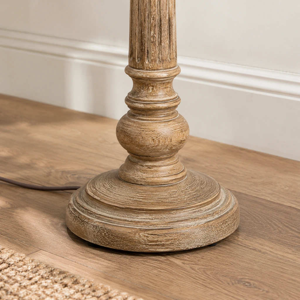 Close detail of the carved lower pedestal and stable floor-contact base