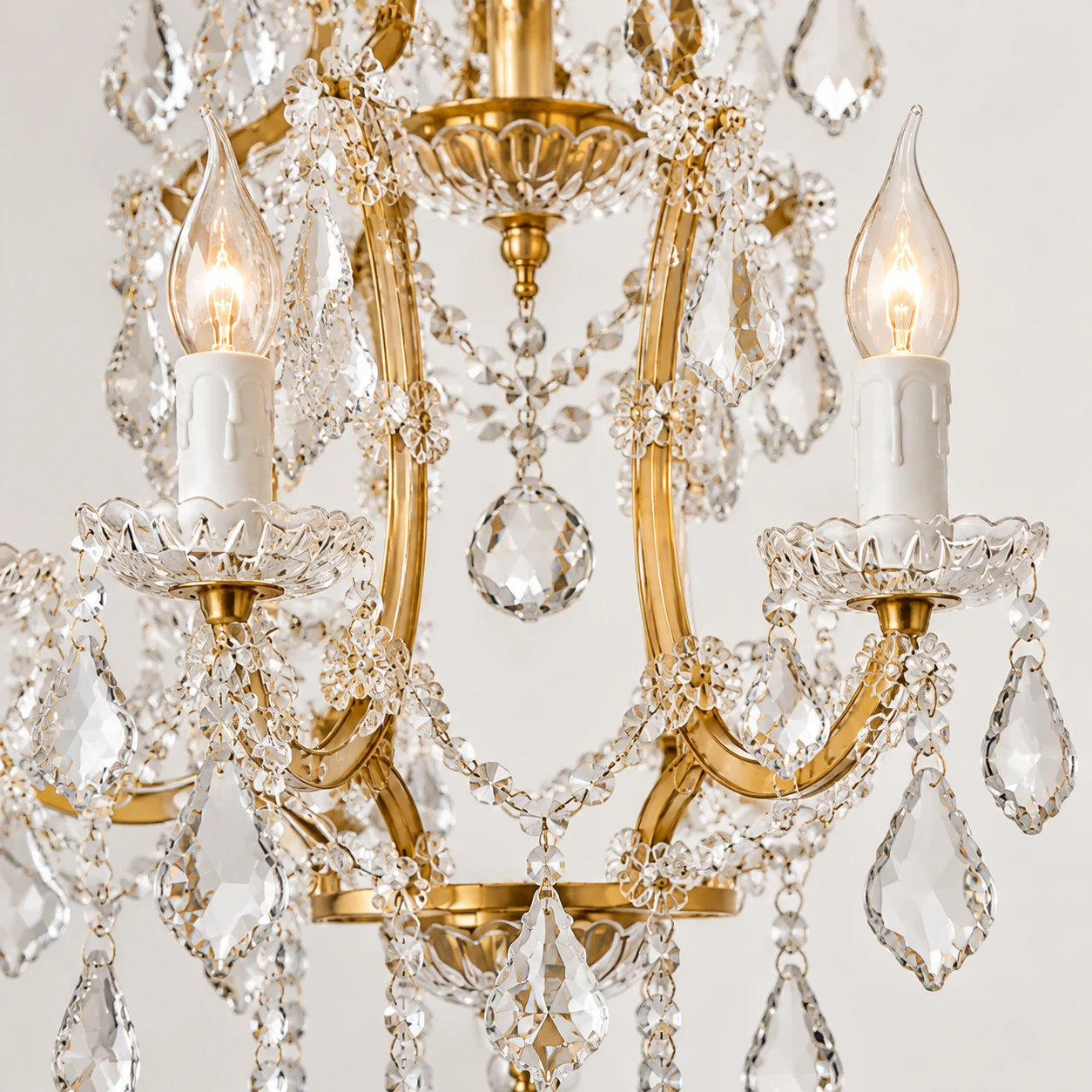 Close view of the Aurelia 6-Light curved gold arms and crystal drops
