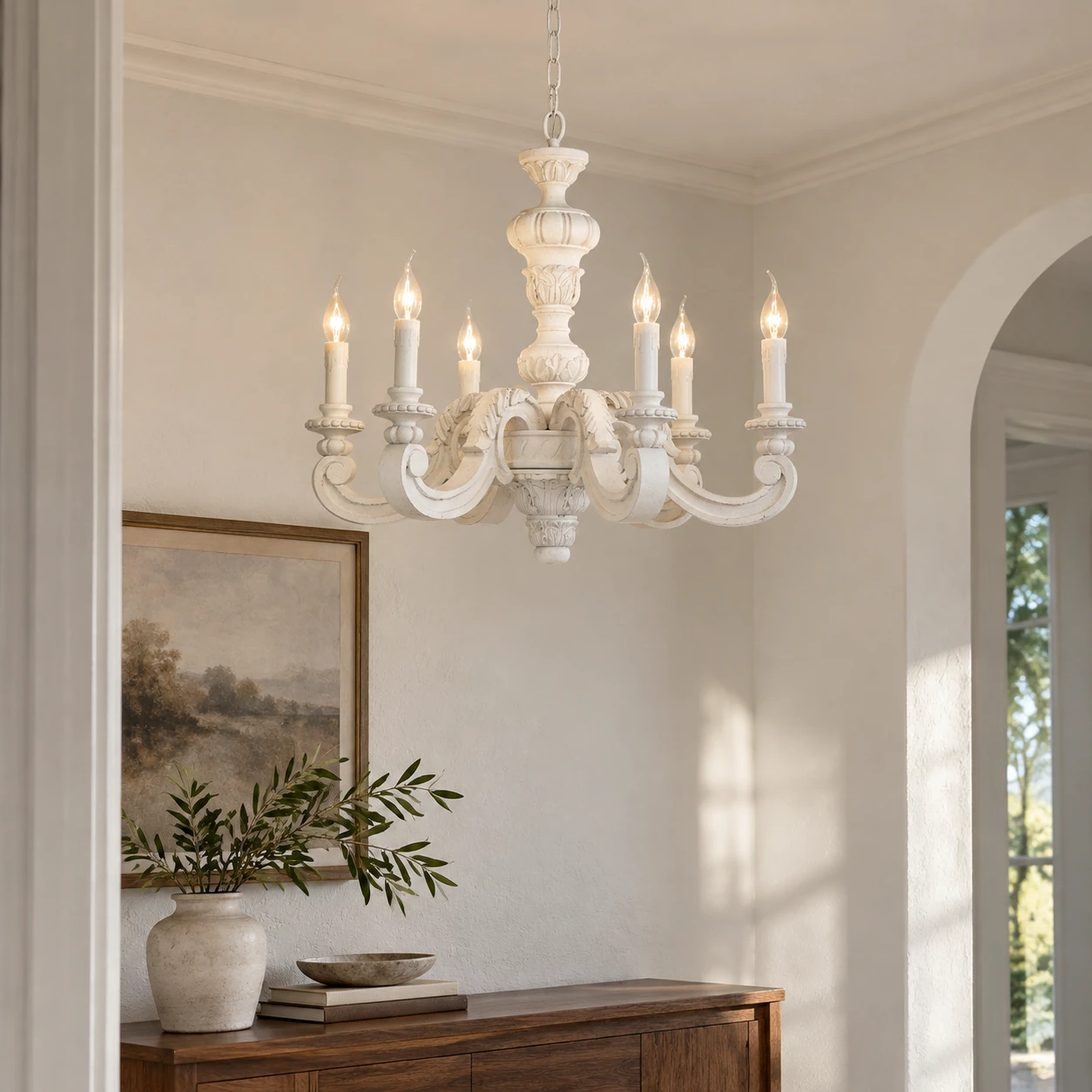 Elise White carved chandelier over an entry console