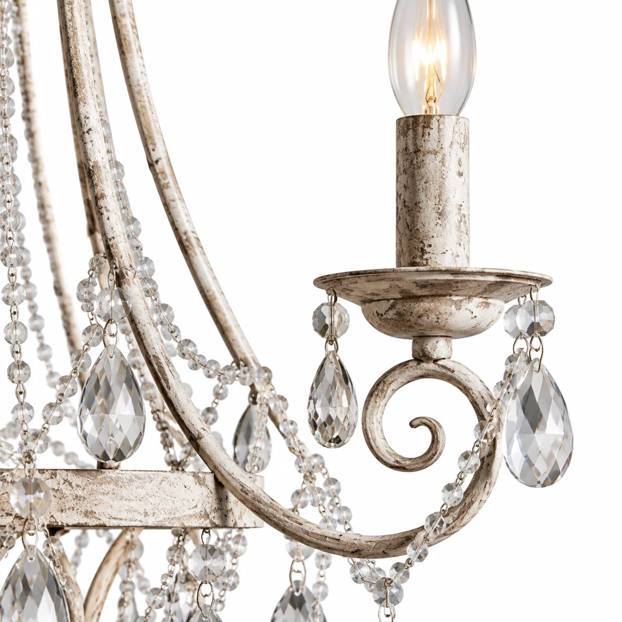 Close detail of the wrought-iron arm, candle socket, and crystal connections