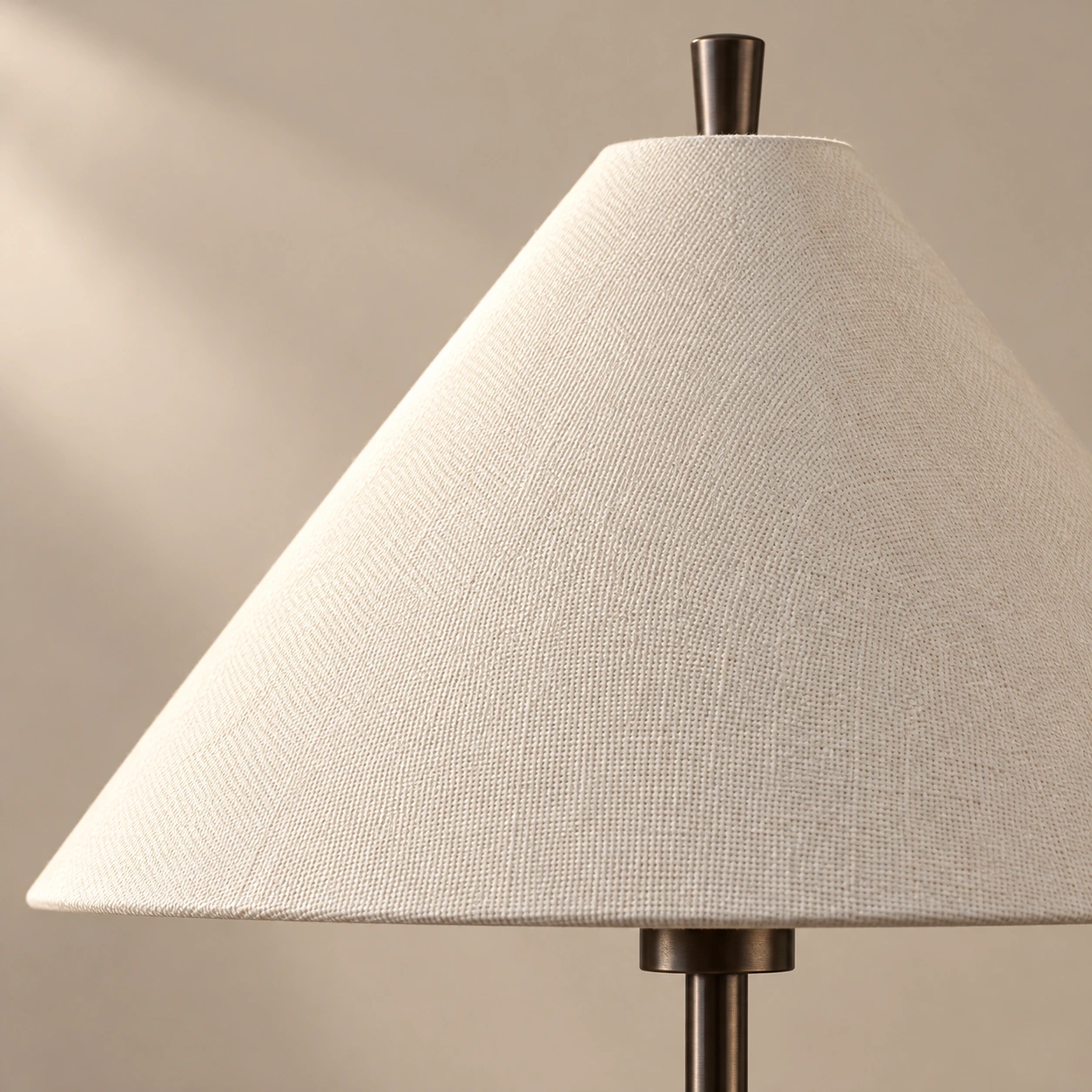 Close-up of the cream fabric cone shade and its woven texture