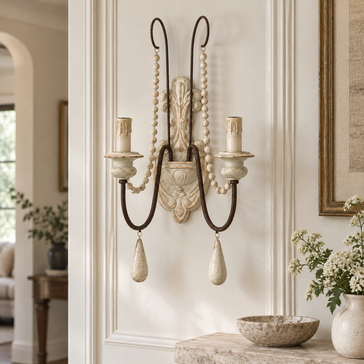 Vintage white double-arm wall sconce in a light hallway setting