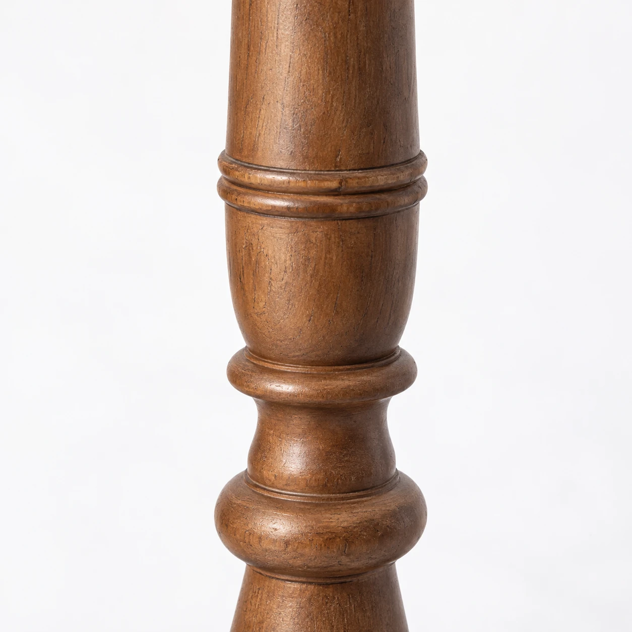 Close detail of the turned wood stem and carved rings