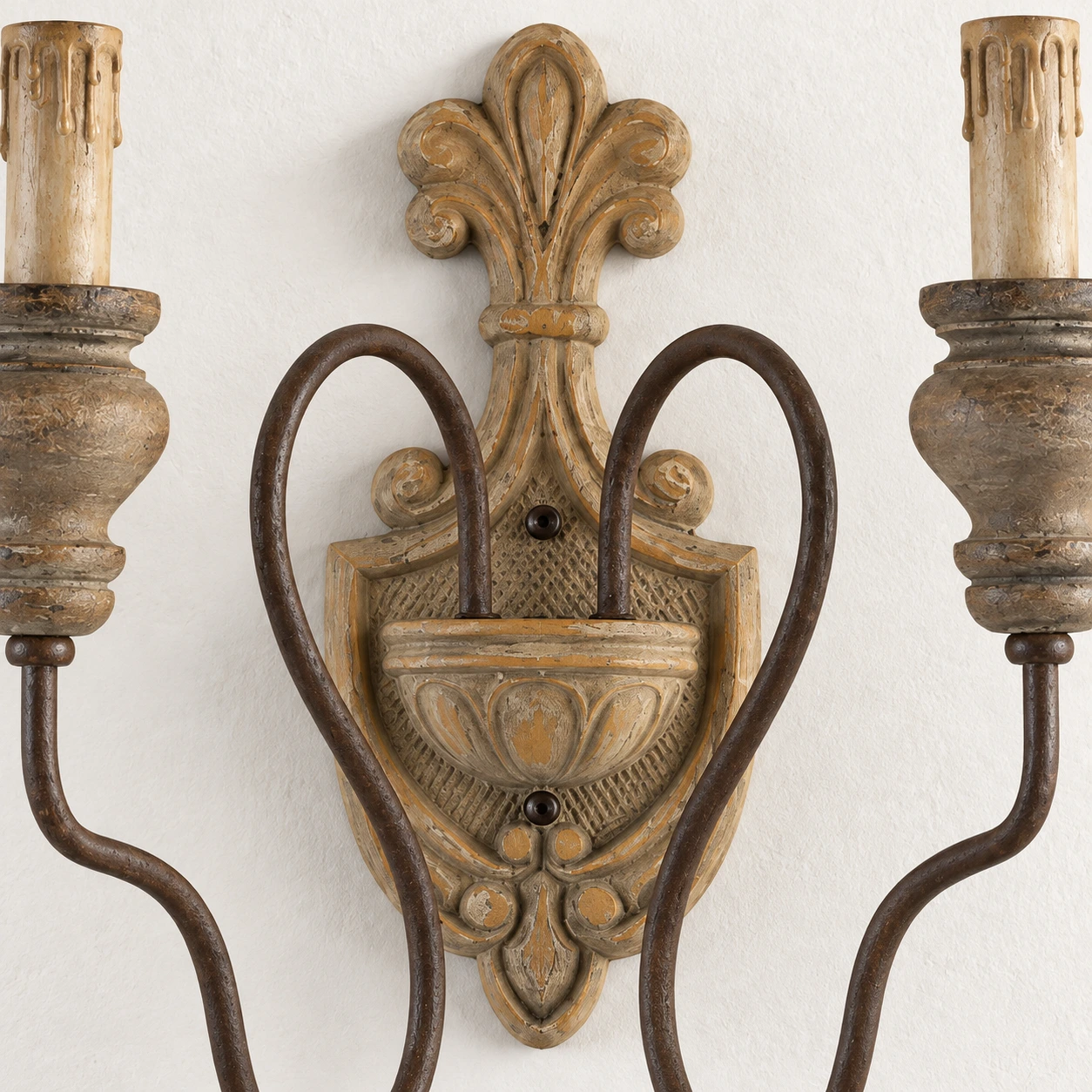 Close detail of the standard carved wood backplate and curved iron arm roots
