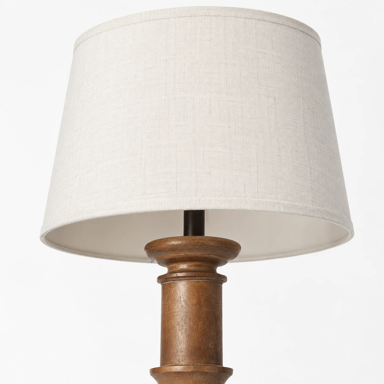 Close detail of the fabric shade and turned wood upper connection