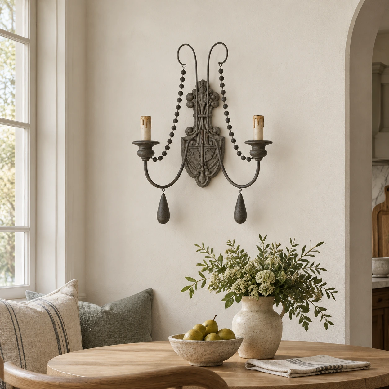 Gray double-arm wall sconce above a quiet breakfast nook