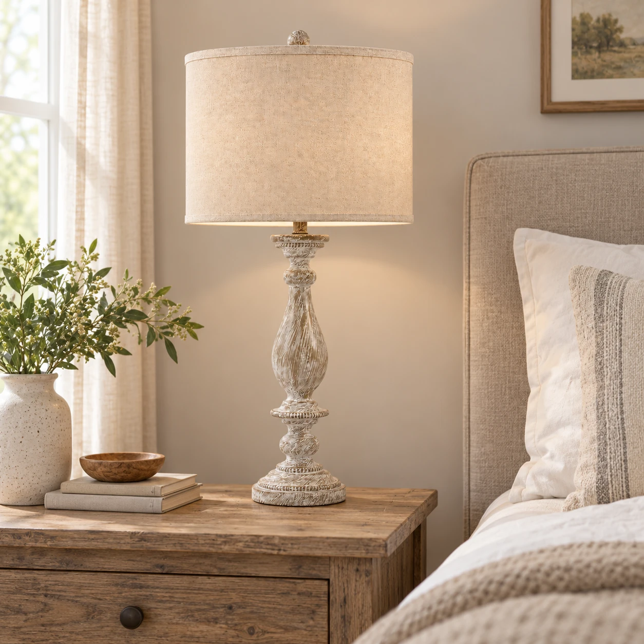 Camille table lamp on a wood nightstand beside an upholstered bed in an ordinary American bedroom