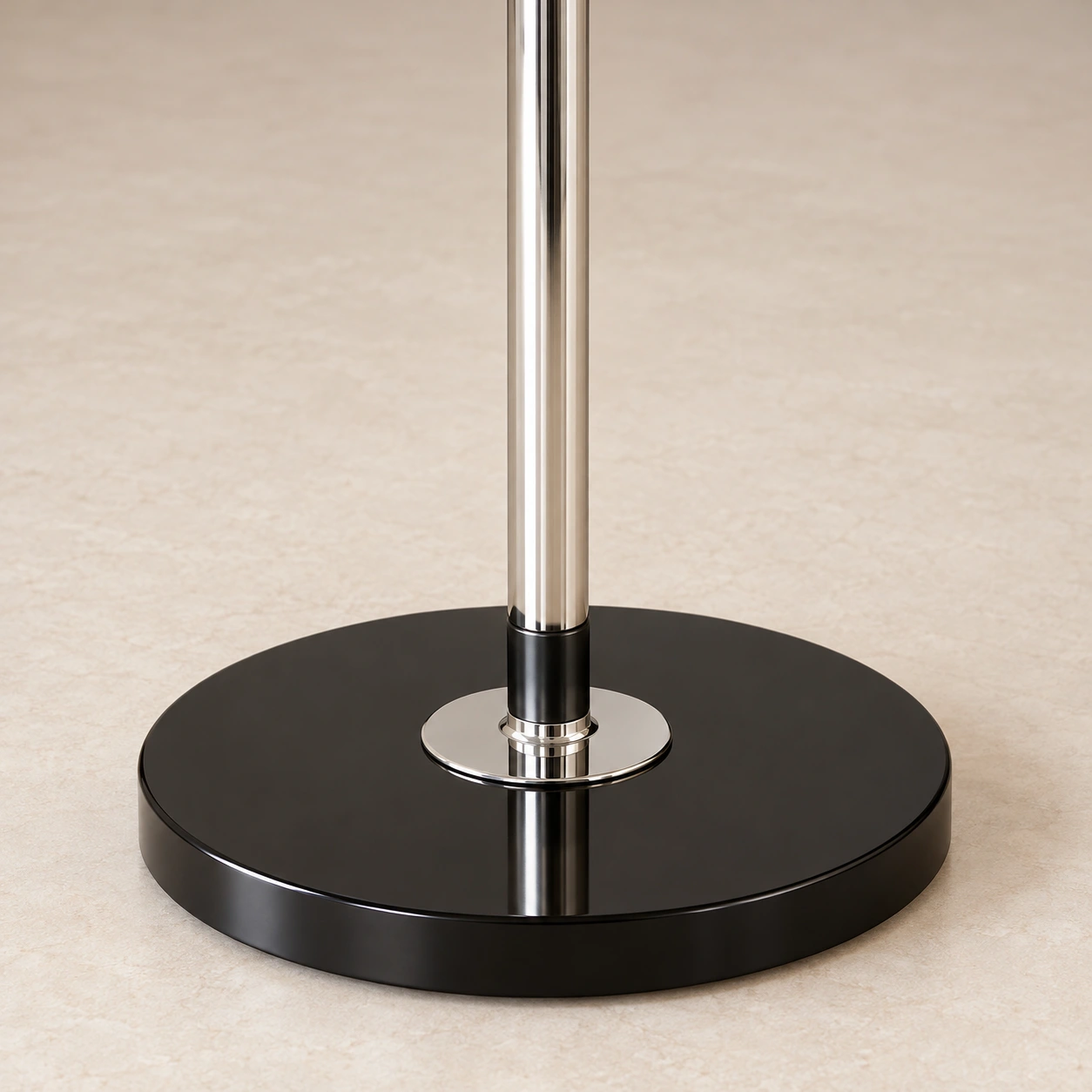 Close view of the chrome-finished stem and black circular floor base