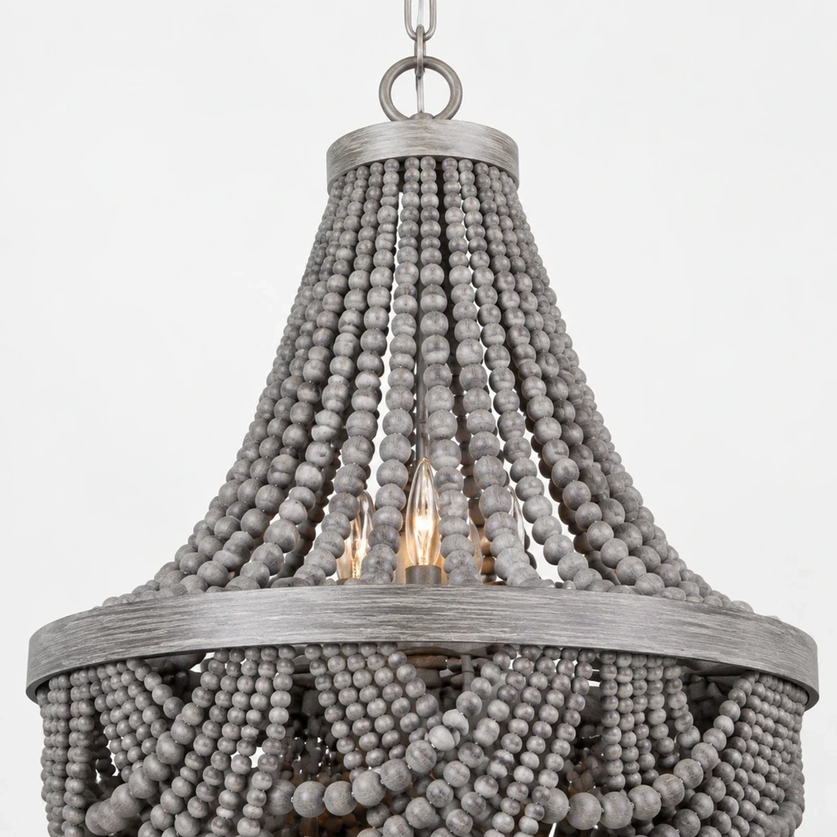 Close detail of layered gray wood bead strands and broad circular ring