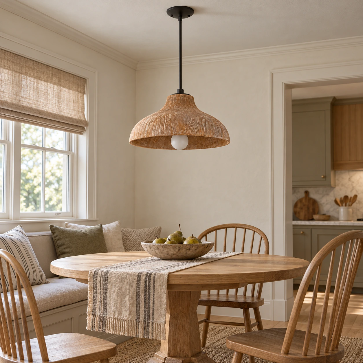 Carved wood pendant light over a breakfast table