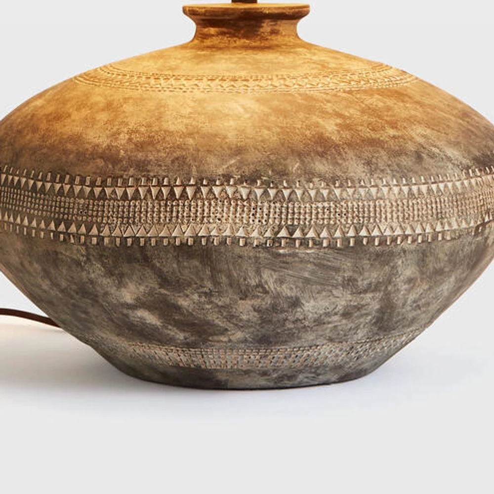 Close view of the carved geometric band and distressed wood finish