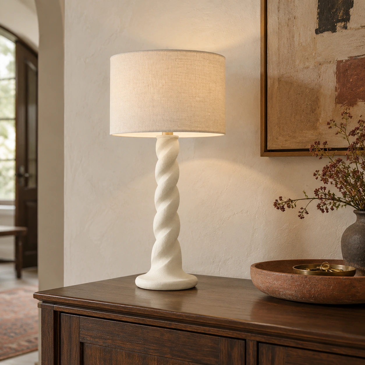 Twisted wood table lamp on an entryway sideboard