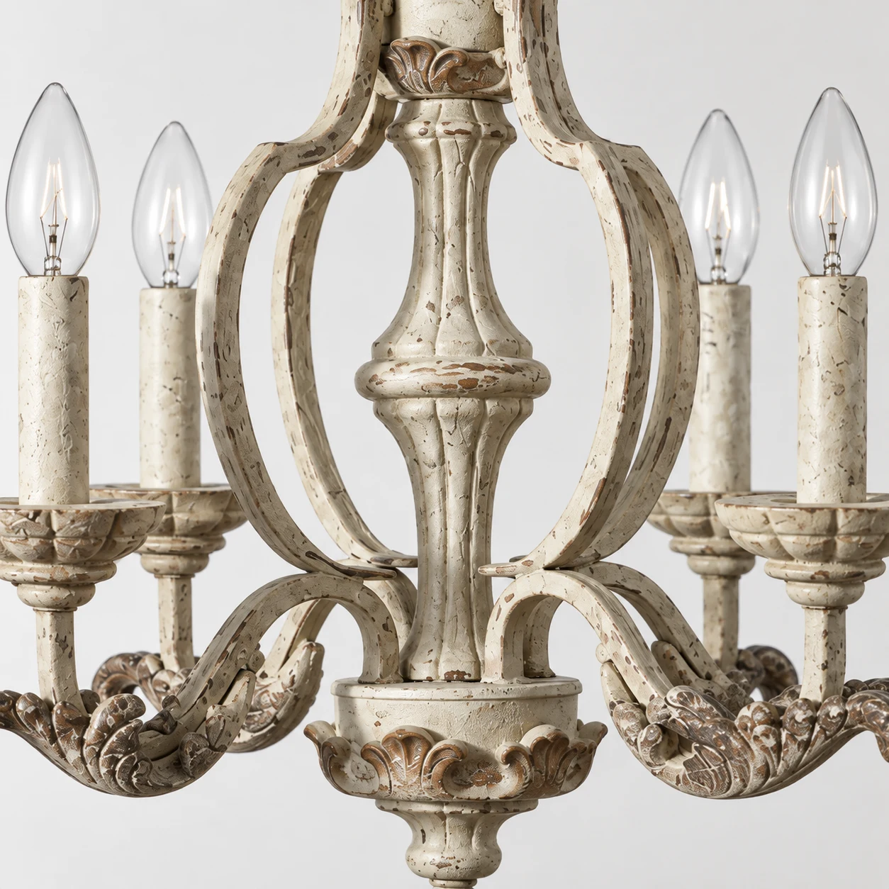 Close view of the chandelier central carved wood body and distressed finish