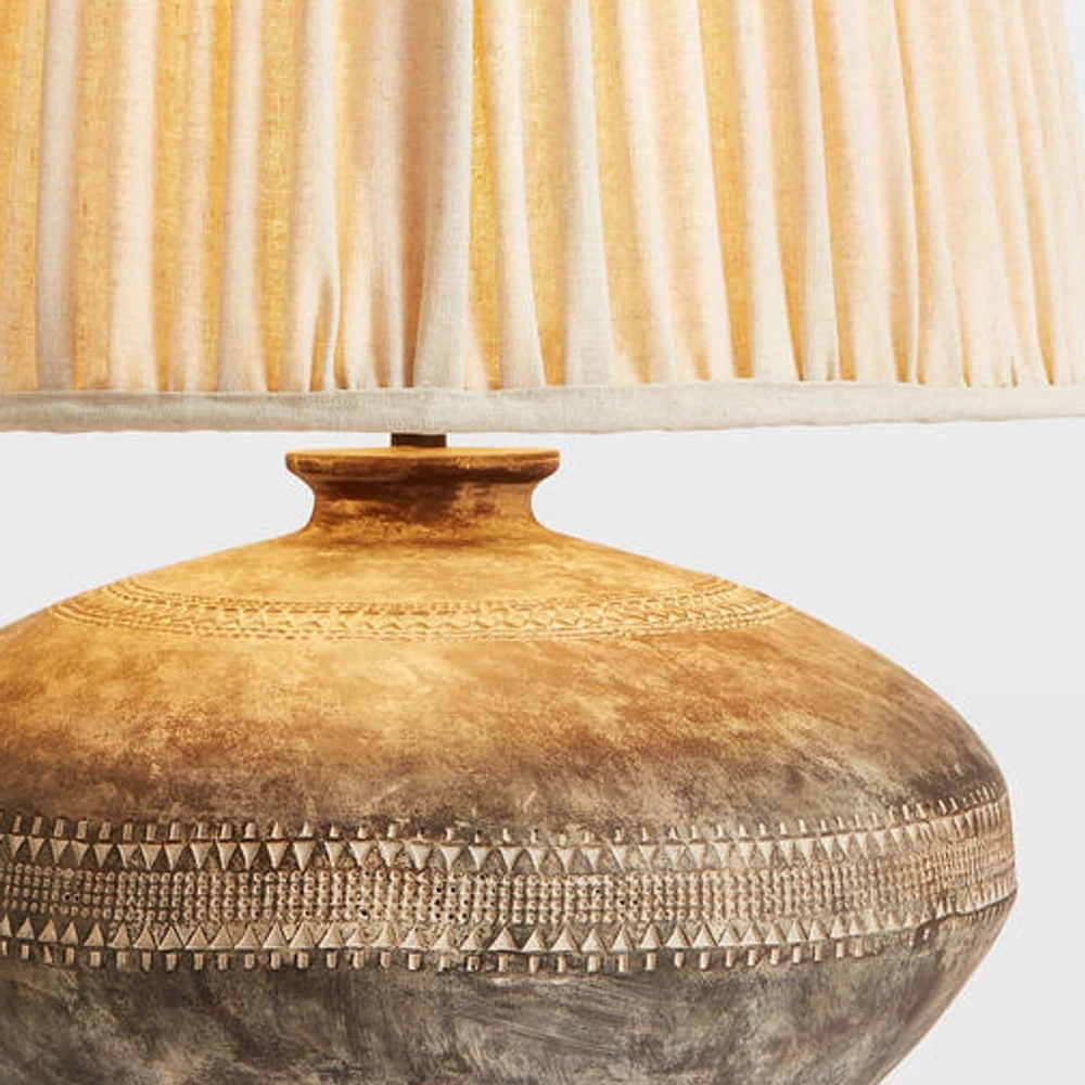 Close view of the fabric shade edge, short connector and wooden neck