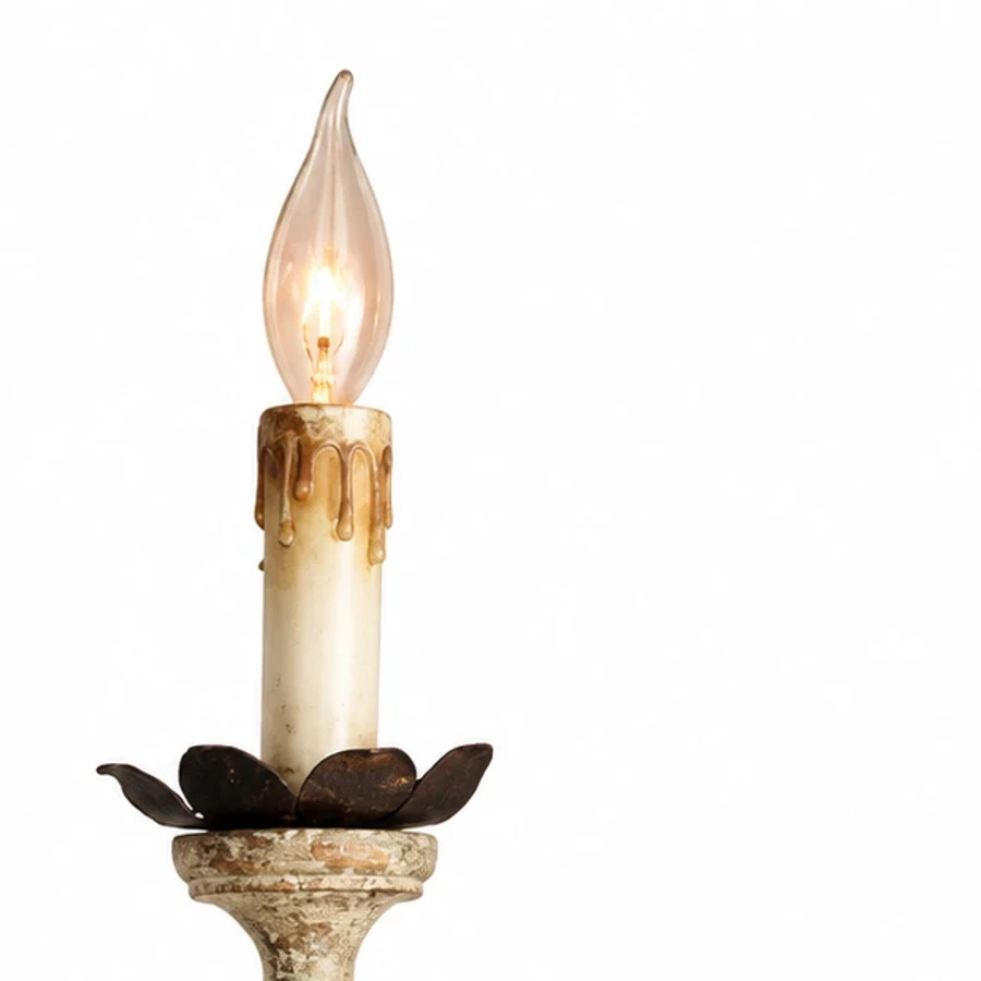 Close view of a distressed ivory candle holder and dark iron cup