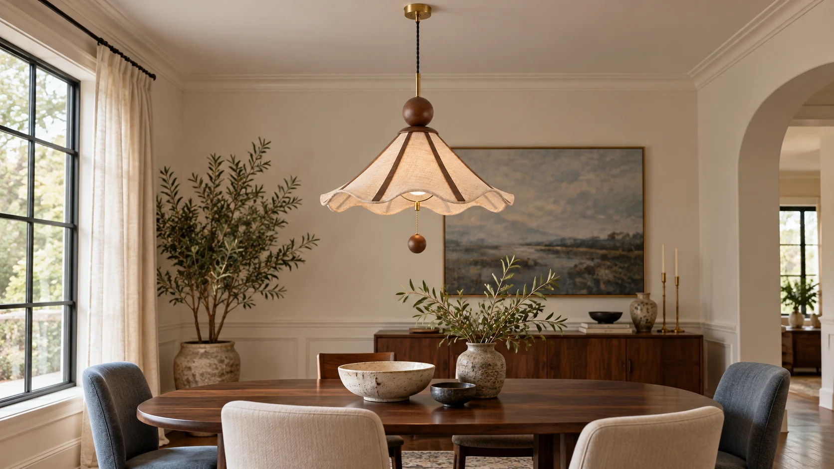 Amelie fabric and wood pendant centered above a dining table