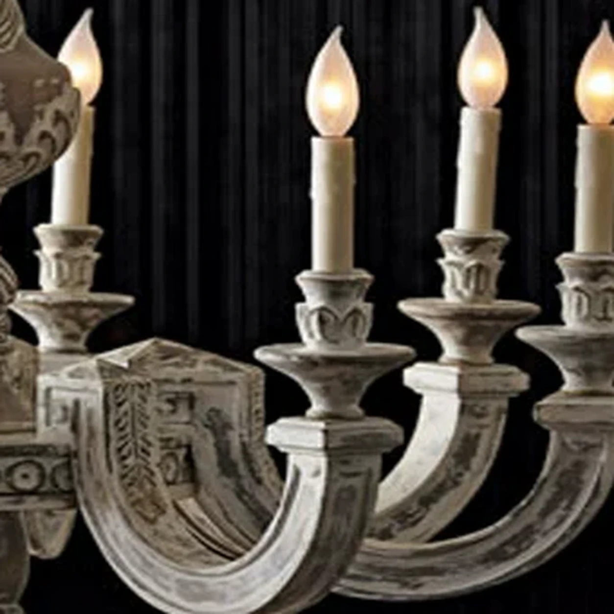 Close view of a carved wood candle arm, cup, and socket detail