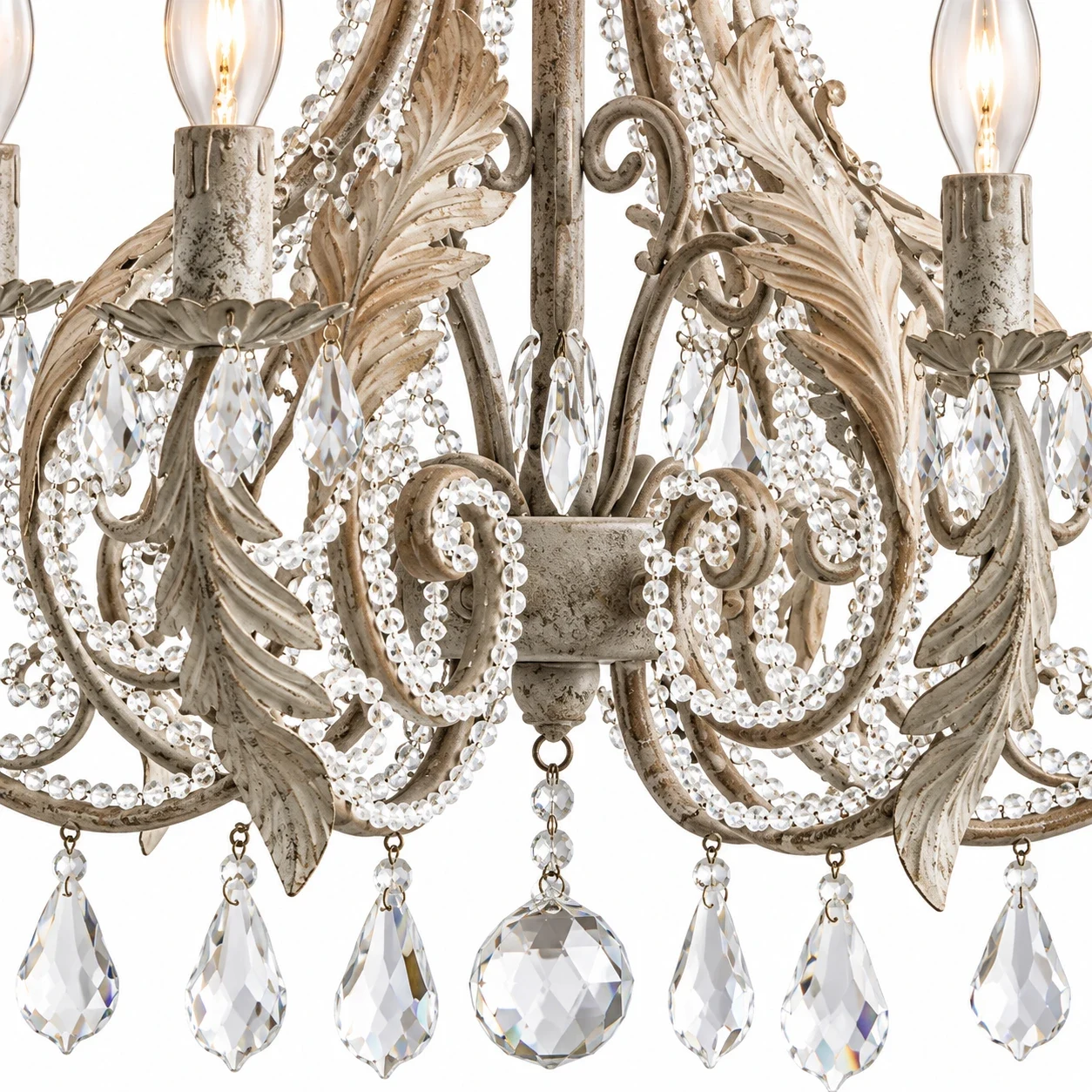 Close view of scroll leaf iron arms and crystal accents